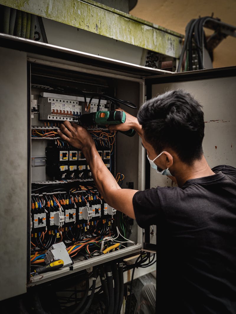 M-CO technician working on a circuit breaker panel